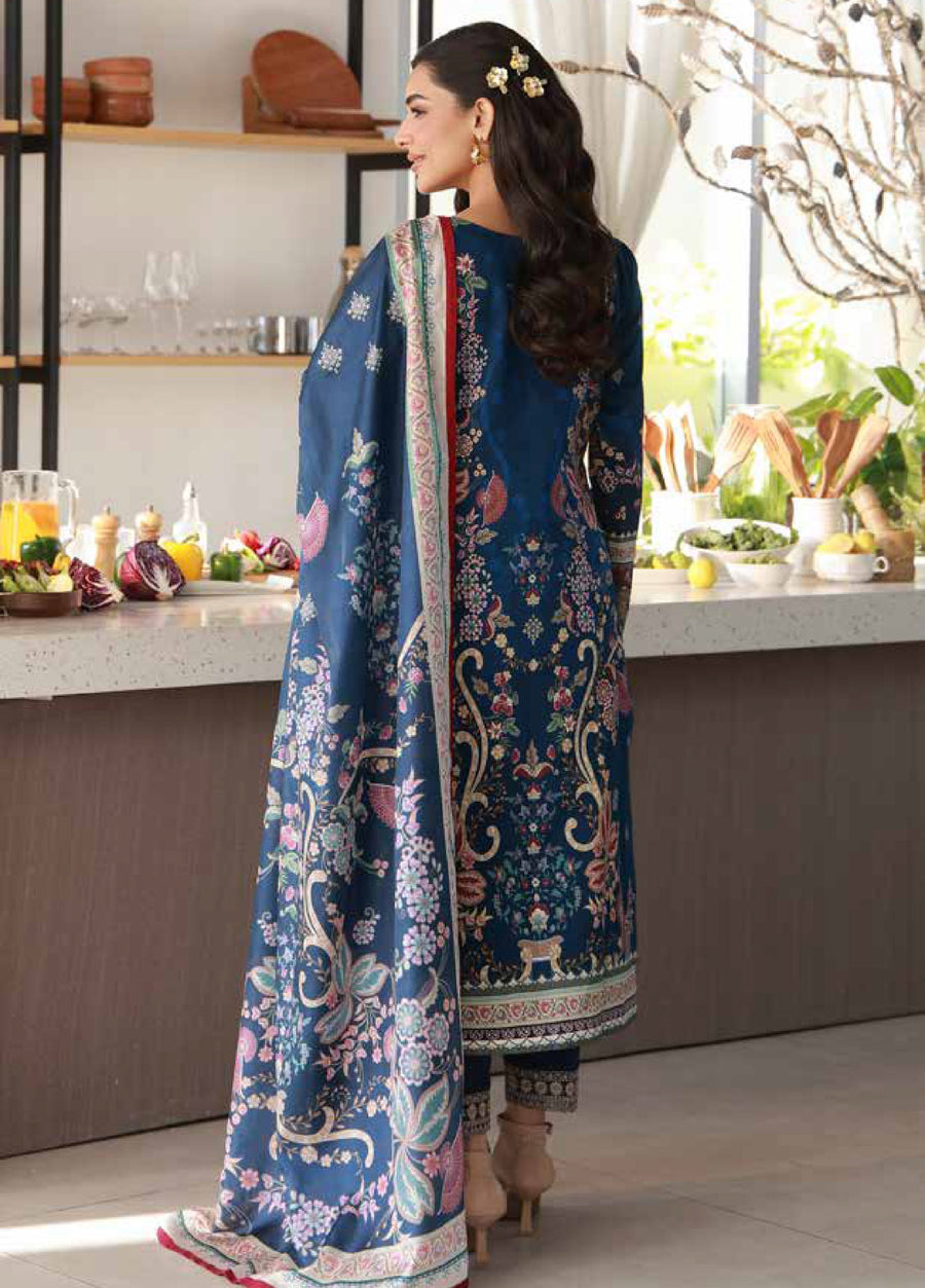 Rear view of a woman showcasing the back embroidery of the deep blue lawn shirt and the full length of the floral printed chiffon dupatta with border trim