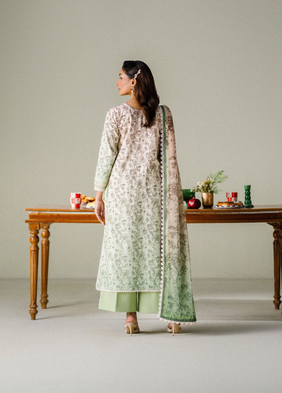 Back view of woman wearing the printed lawn suit, showcasing the detailed floral print and scalloped lace trims on the shirt and dupatta.