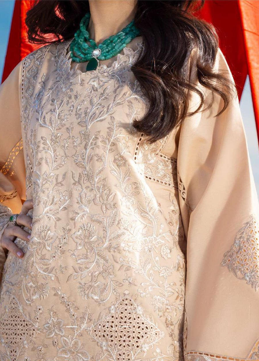 Focused close-up of embroidered fabric with floral patterns and lace cutwork on beige shirt, highlighting delicate craftsmanship