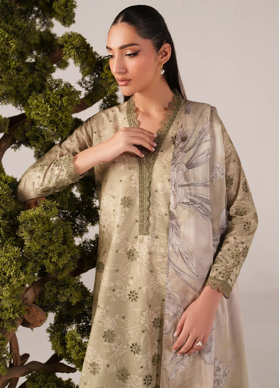 Close-up of woman wearing beige embroidered lawn suit showing intricate floral embroidery around neckline and sleeve cuffs with delicate lace trim