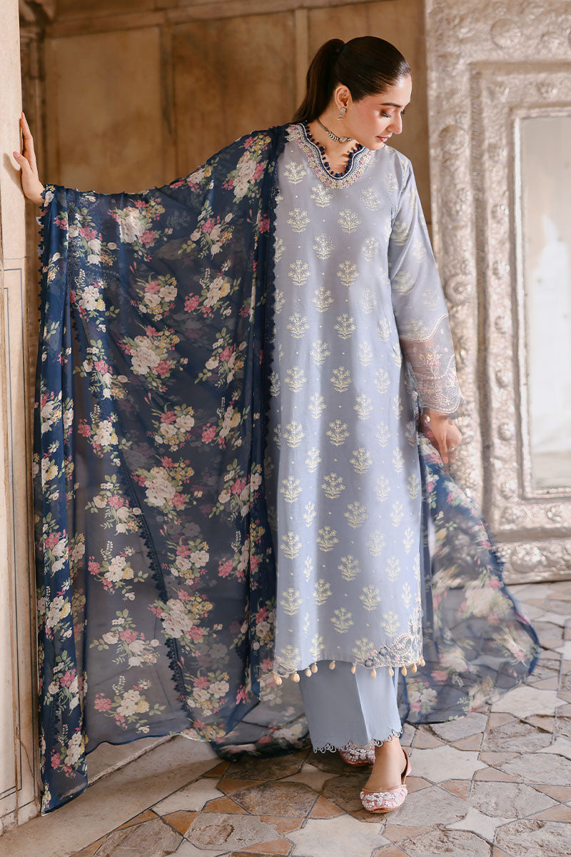 Full view of sky blue embroidered lawn suit with navy floral chiffon dupatta spread out, showing shirt and trousers