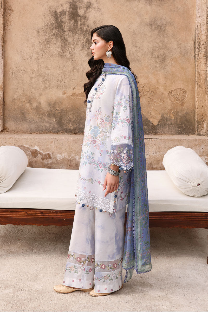 Side view of woman standing in Vintage Petal lawn suit showing floral print design, embroidered cuff details, and flowing blue chiffon dupatta