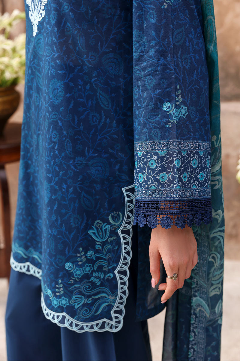 Detailed view of navy blue lawn fabric showing fine floral embroidery, lace trimming on sleeve and scalloped hem