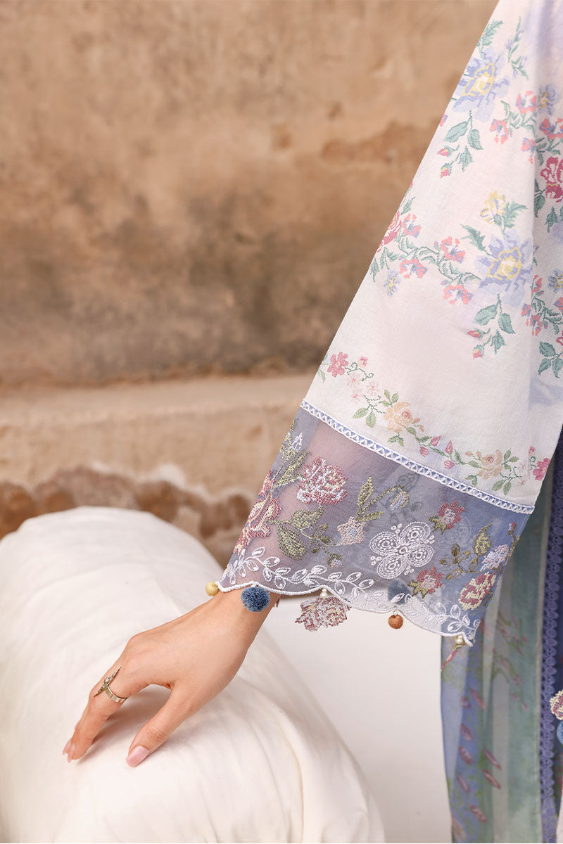 Close-up of embroidered floral details and pom pom accents on the sleeve cuff of the Vintage Petal lawn shirt