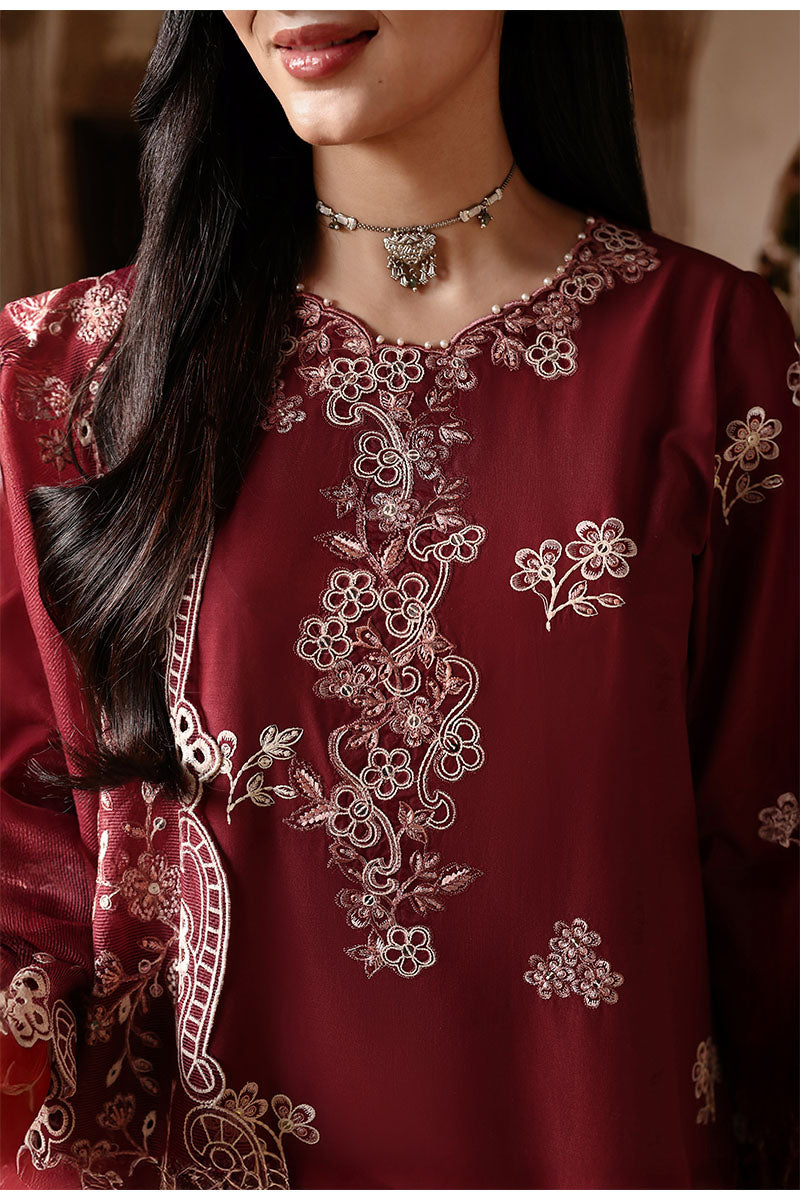 Close-up of neckline and chest embroidery on crimson lawn suit featuring delicate floral patterns and scalloped edges