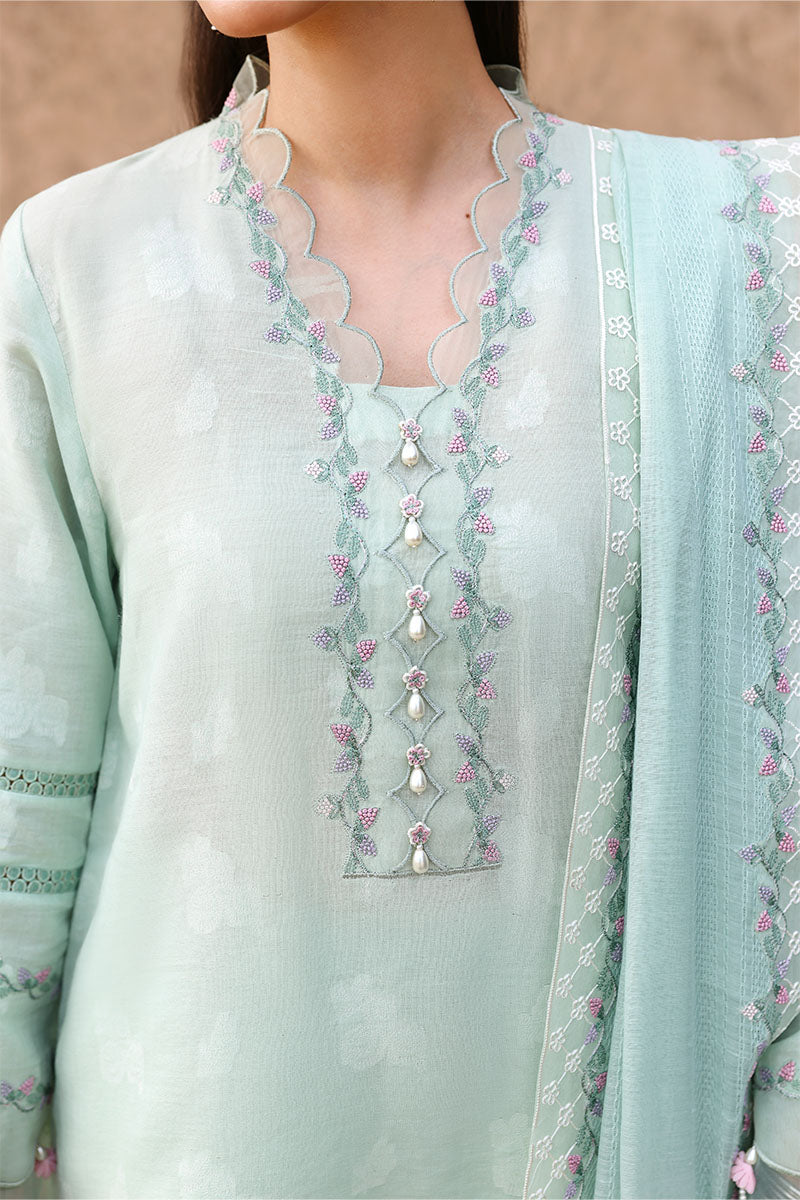 Close-up of neckline featuring scalloped embroidery with pink floral accents and pearl bead detailing