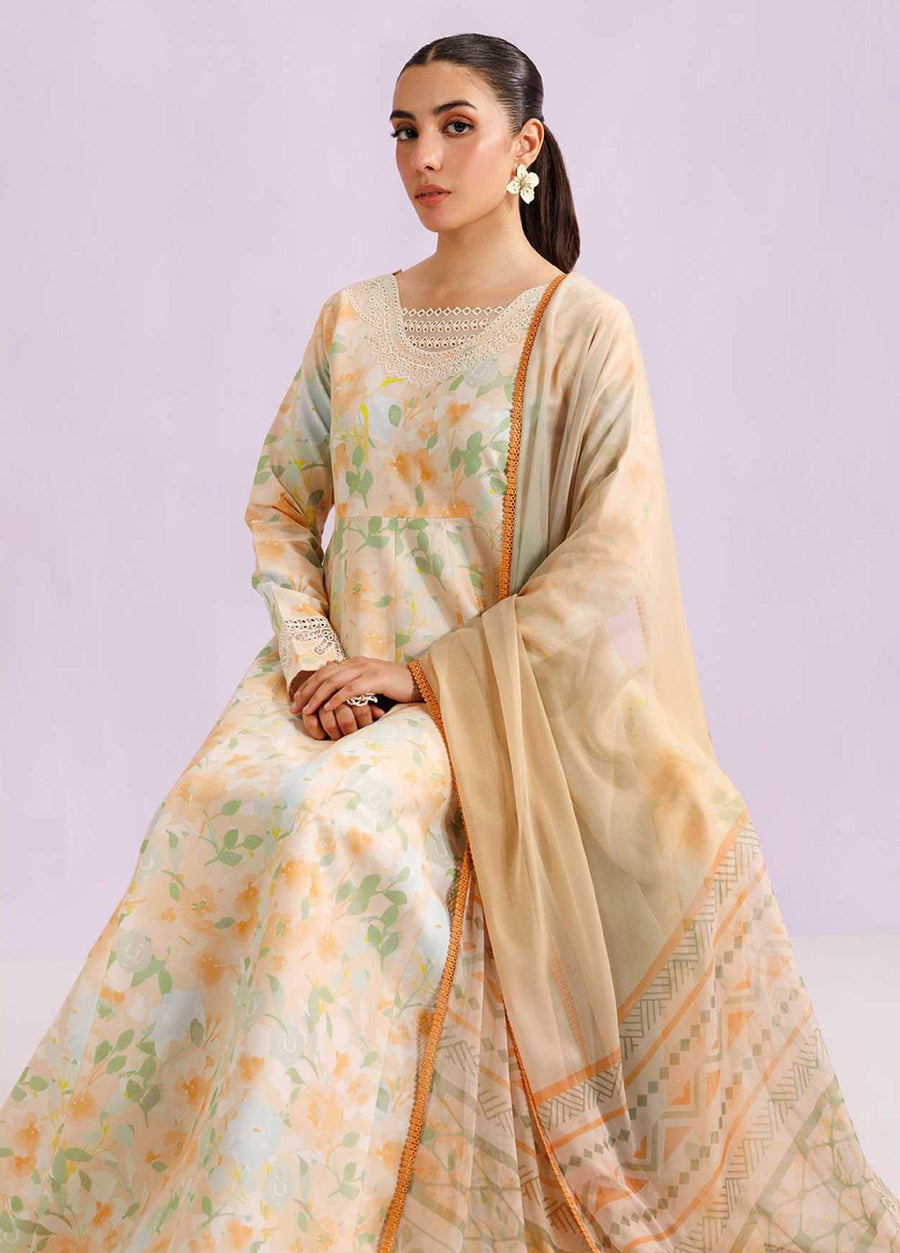 Woman seated with a delicate chiffon dupatta draped over her shoulder, wearing a floral embroidered lawn suit with lace details on the neckline and cuffs.