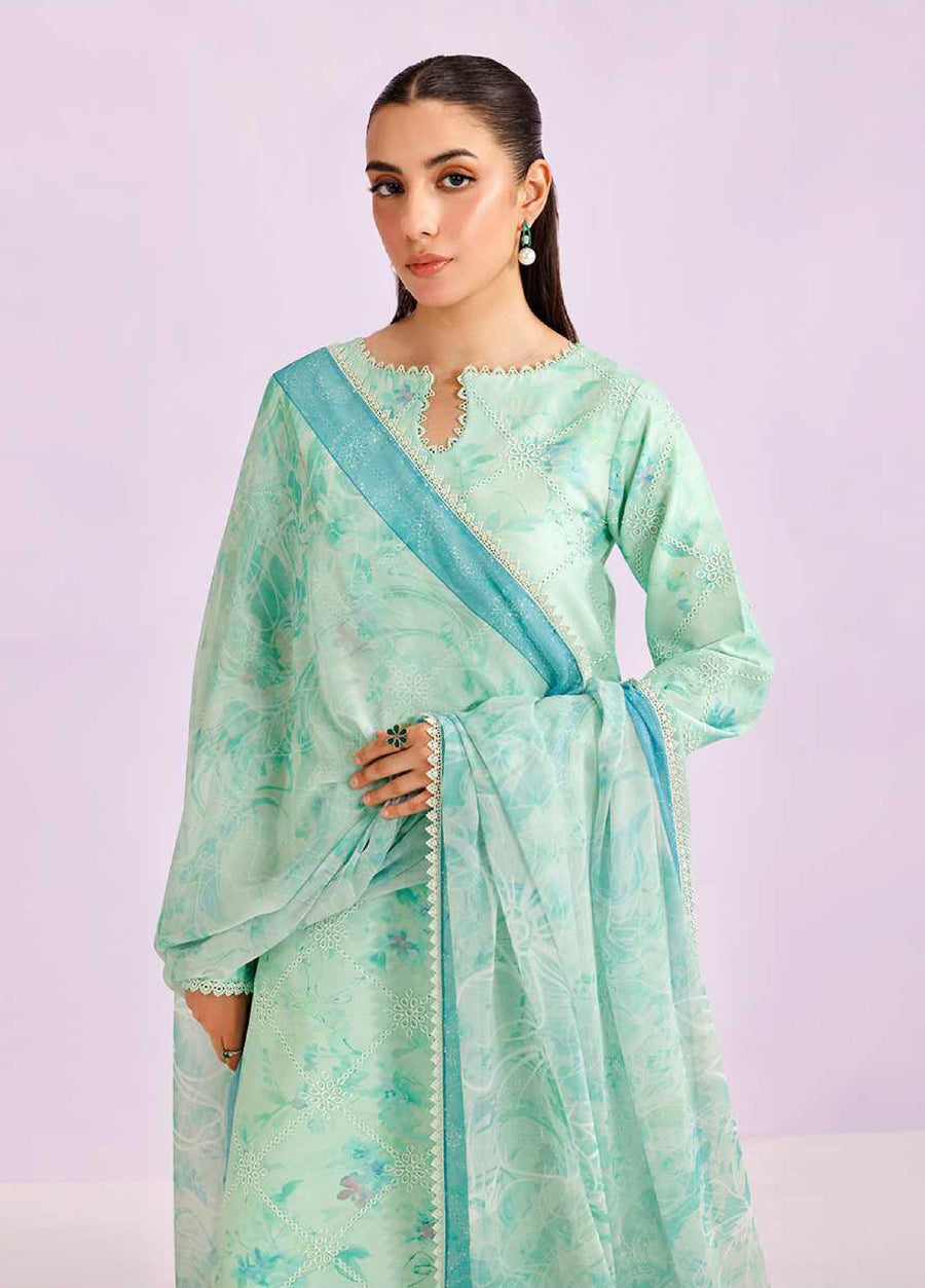 Close-up of woman in mint green embroidered lawn suit showing detailed floral embroidery on the kurta and delicate printed chiffon dupatta with lace edging.