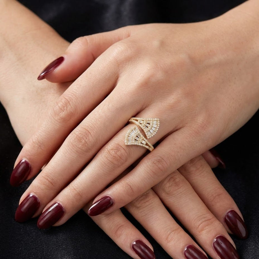 Model wearing the gold fan-shaped ring, showcasing its elegant design and fit on two fingers
