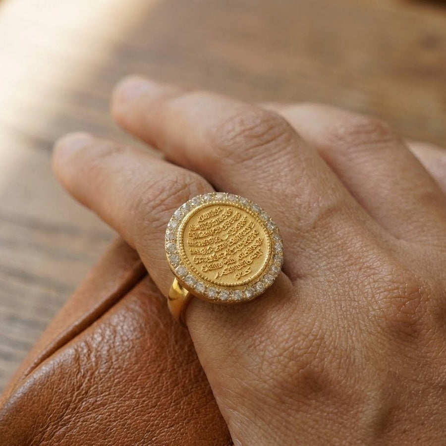 Ayut-Ul-Kursi ring worn on a hand showcasing the elegant gold face and clear stones