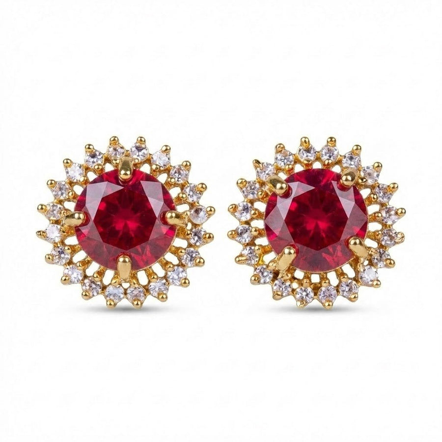 Close-up of red gemstone halo stud earrings with gold setting on white background