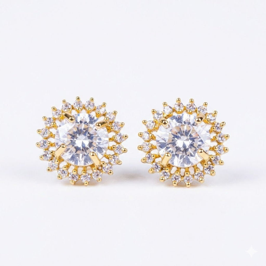 Clear gemstone halo stud earrings with gold setting on white background