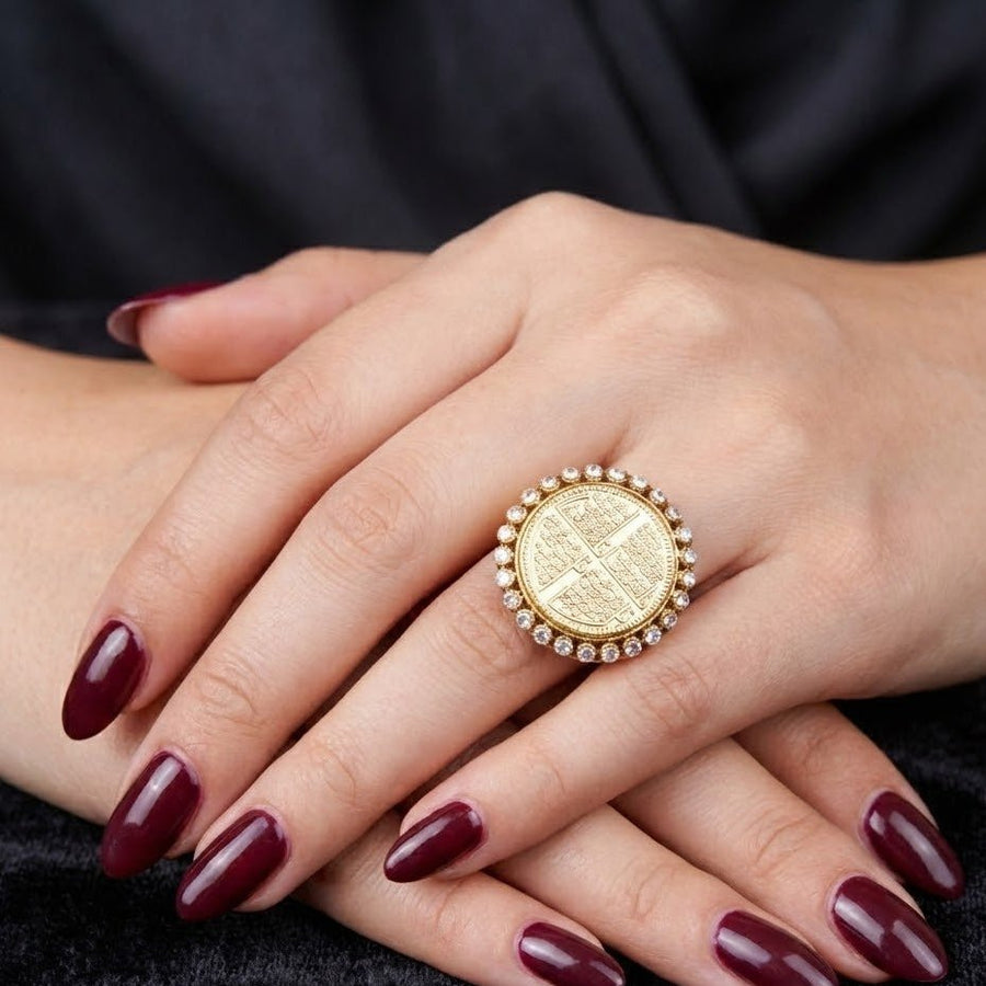 Female hand wearing Chaar Qul ring with deep red manicure, showcasing ring's size and elegance