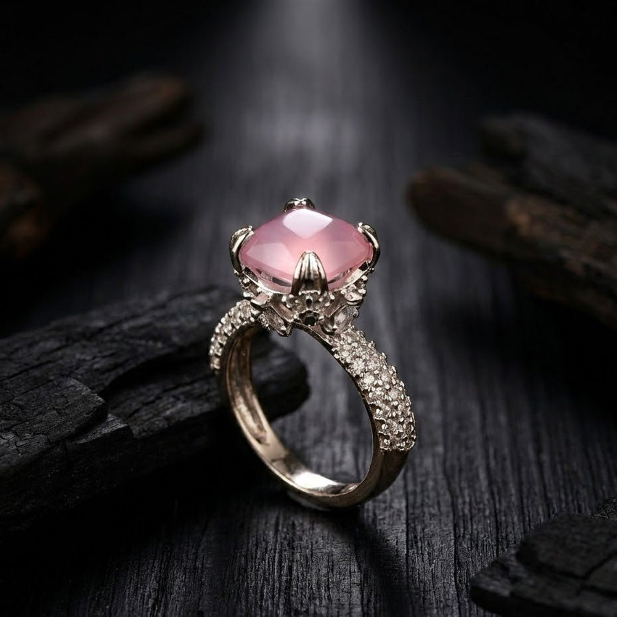 Silver cocktail ring with soft pink cushion-cut gemstone and pave-set accent stones on band