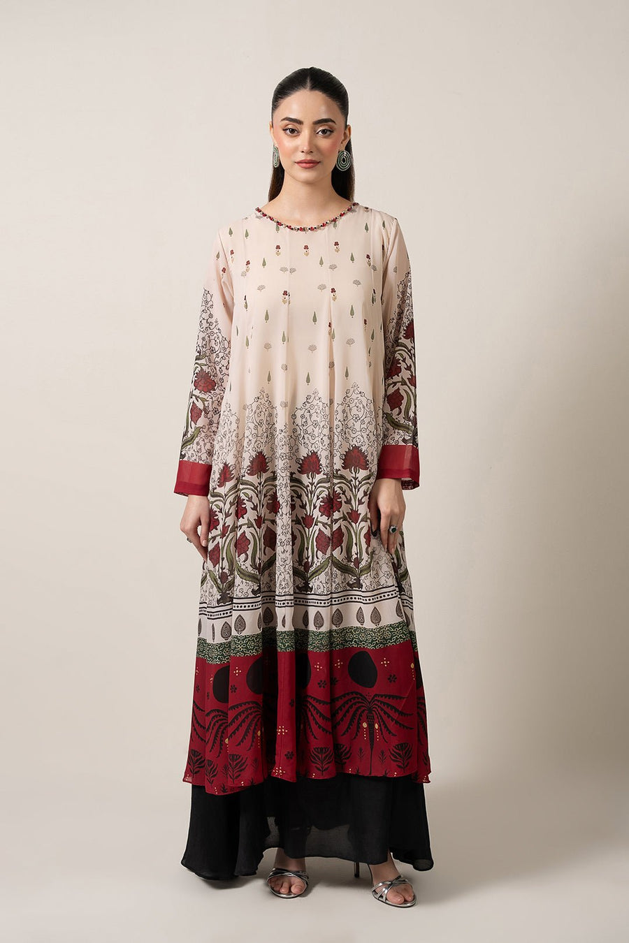 Front view of a woman wearing beige chiffon floral printed pishwas dress with maroon embroidered border at hem and fitted long sleeves