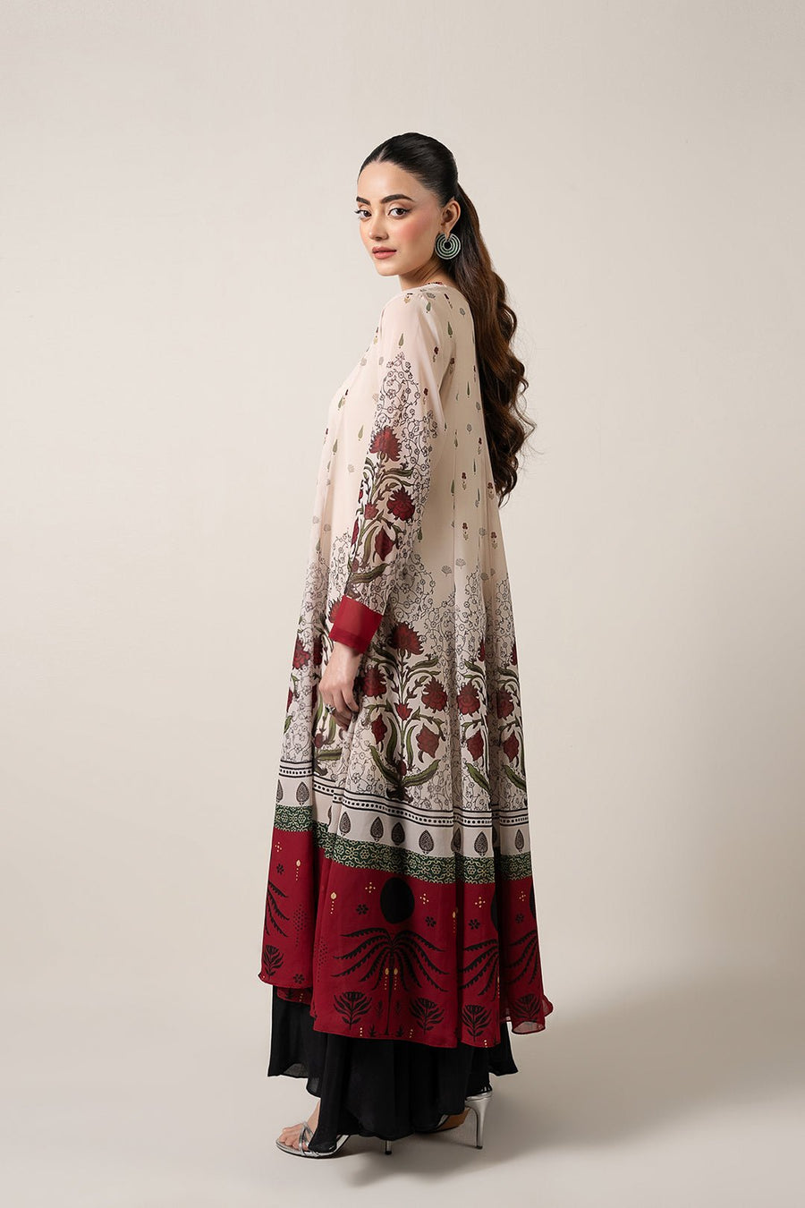 Back-side angle highlighting the flowy silhouette and floral border detailing on chiffon pishwas dress paired with black inner lining