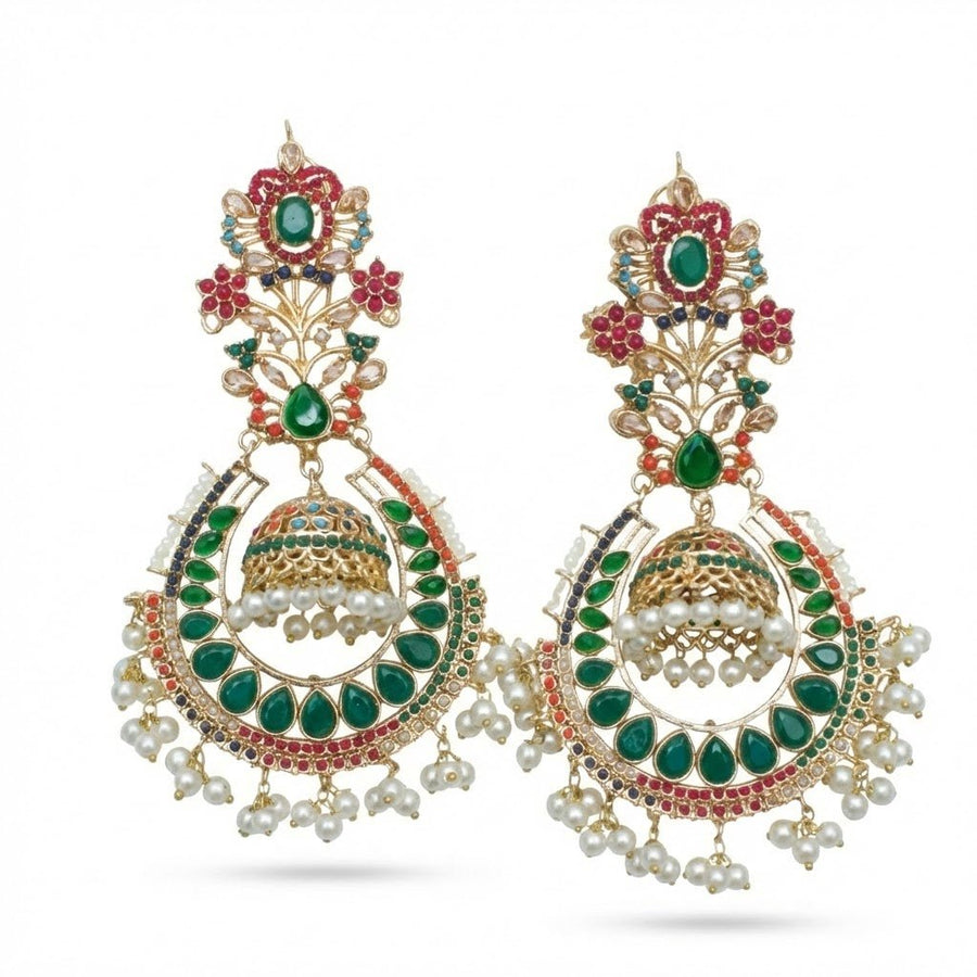 Pair of traditional jhumka earrings in green and pink stones with pearl drops displayed on a plain white background