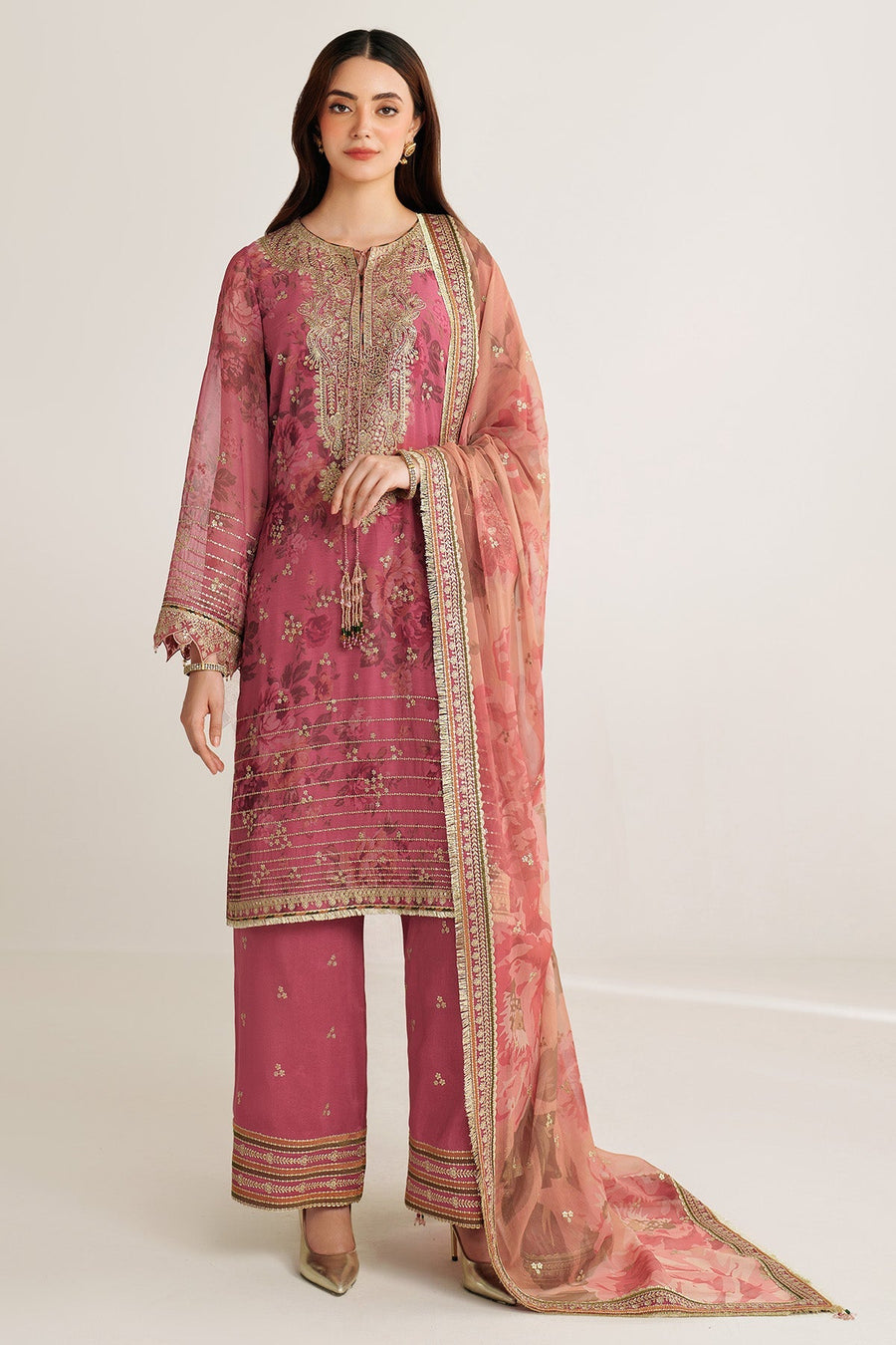 Front full-length view of woman in mauve-pink embroidered chiffon suit and floral printed dupatta