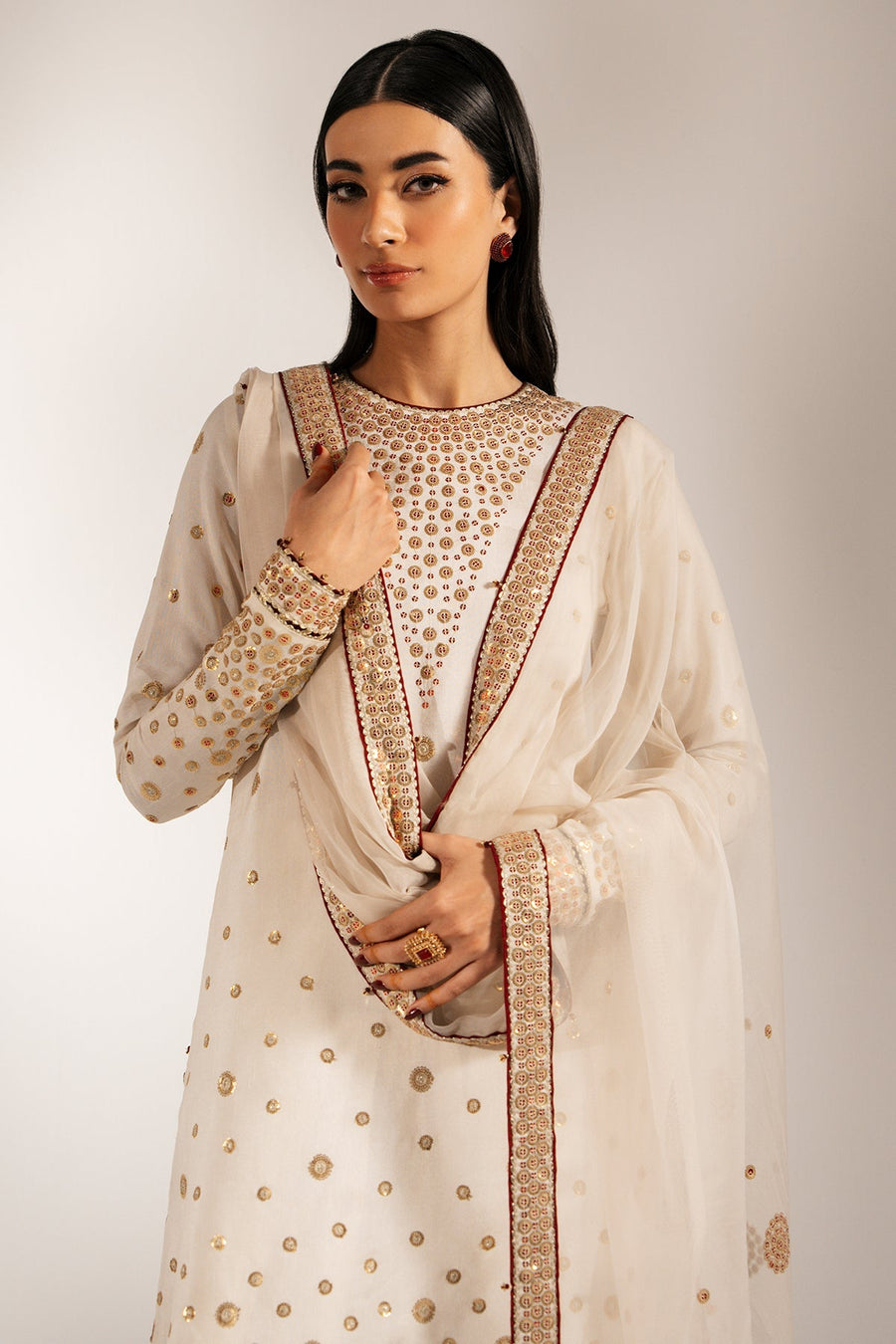 Back view of model displaying the embroidery flow on shirt and the full length of the detailed dupatta.