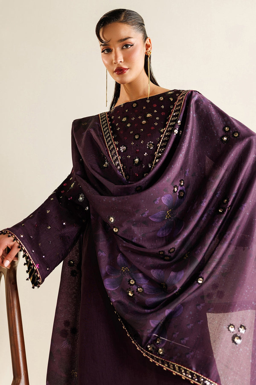 Close-up front view of embroidered floral sequins and fabric texture on kameez