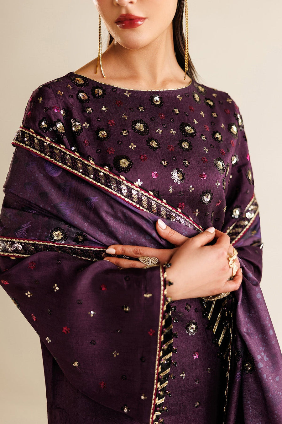 Model gracefully holding embroidered dupatta showcasing intricate sequin work