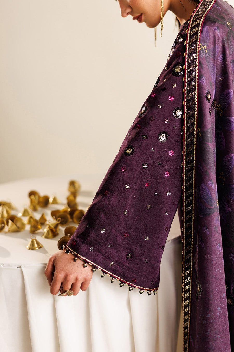 Full length view emphasizing fine embroidery, side slits, and suit’s refined silhouette