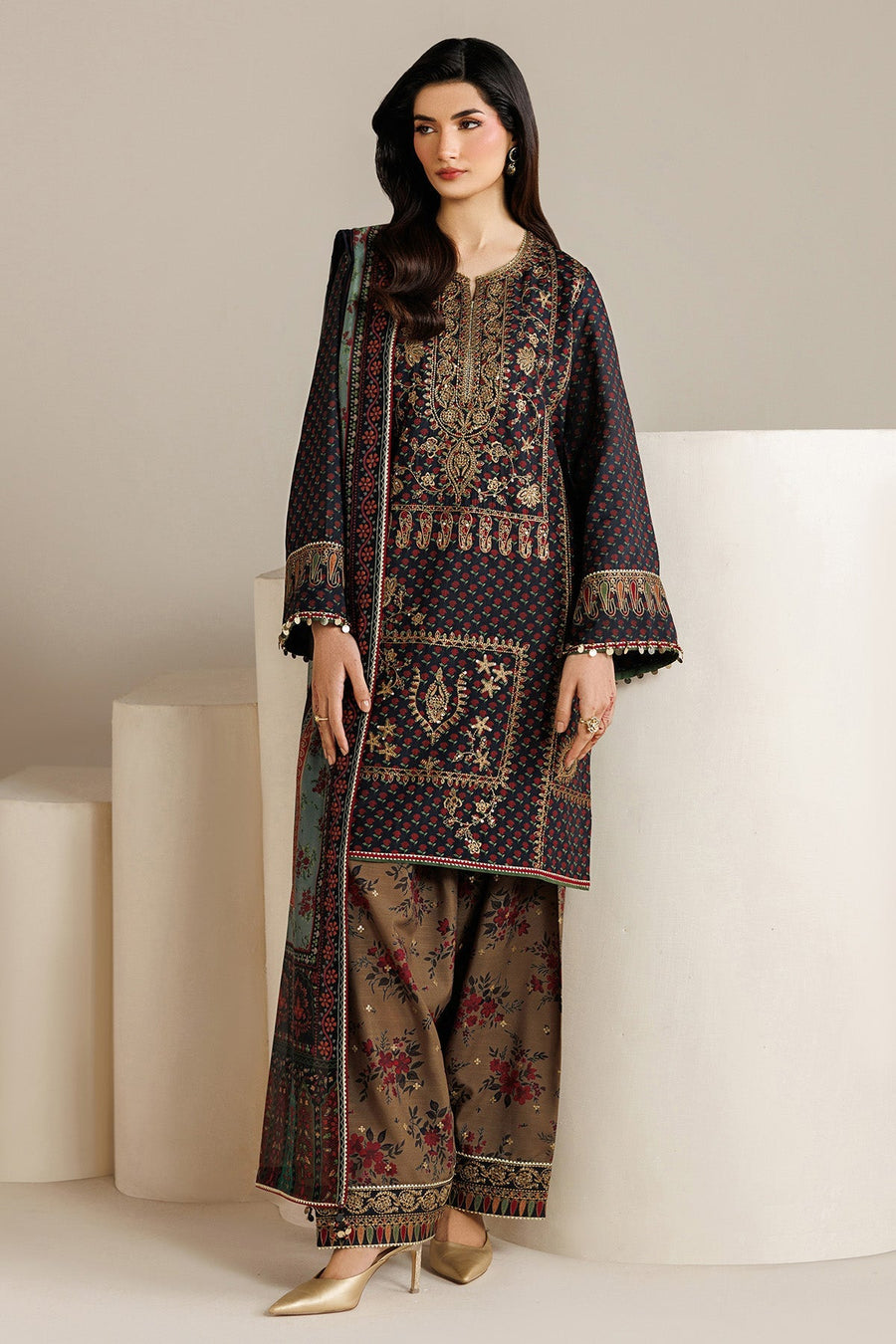 Model adjusting sheer dupatta, showcasing detailed border and overall sophisticated design of the suit