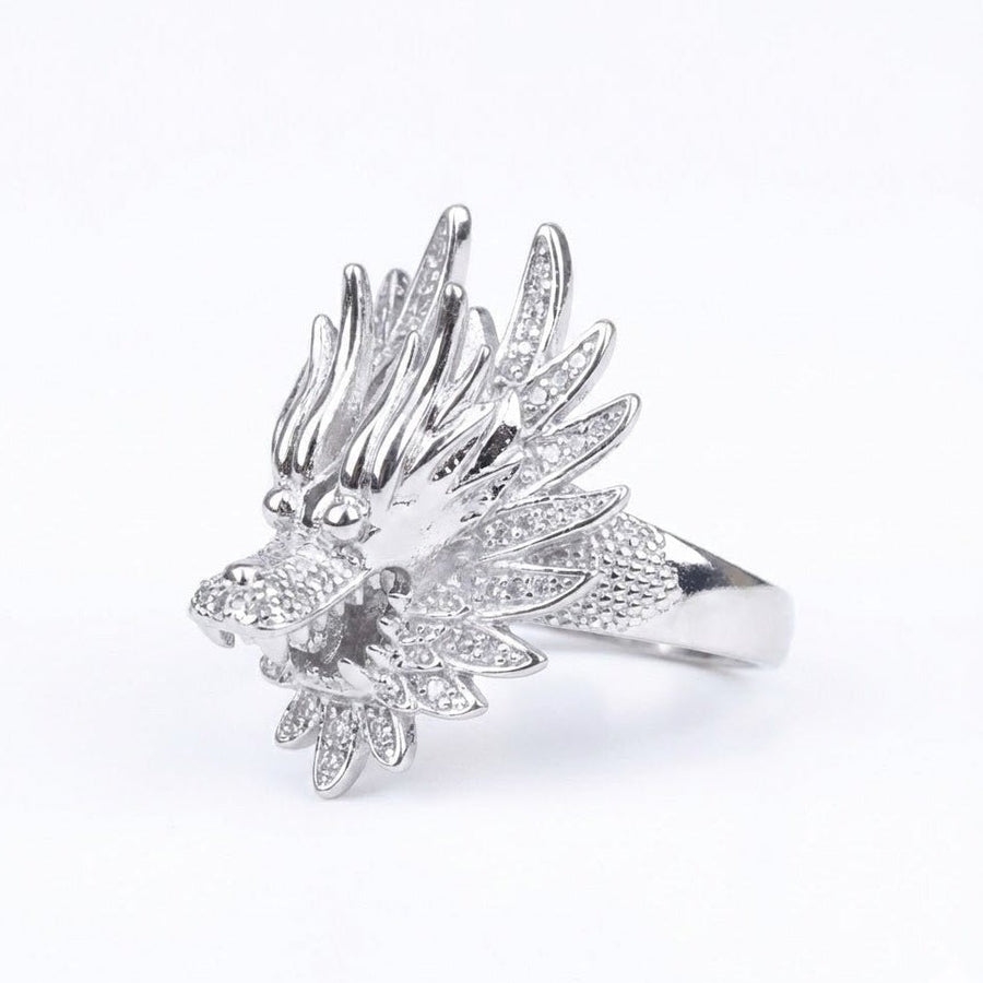 Close-up of polished silver ring with detailed dragon head design featuring textured scales and sharp features