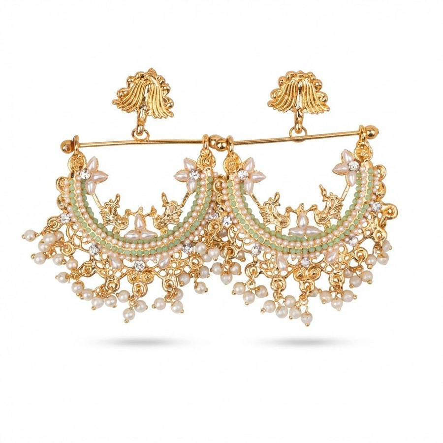 Close up front view of mint green stone and pearl gold-plated jhumka earrings on white background