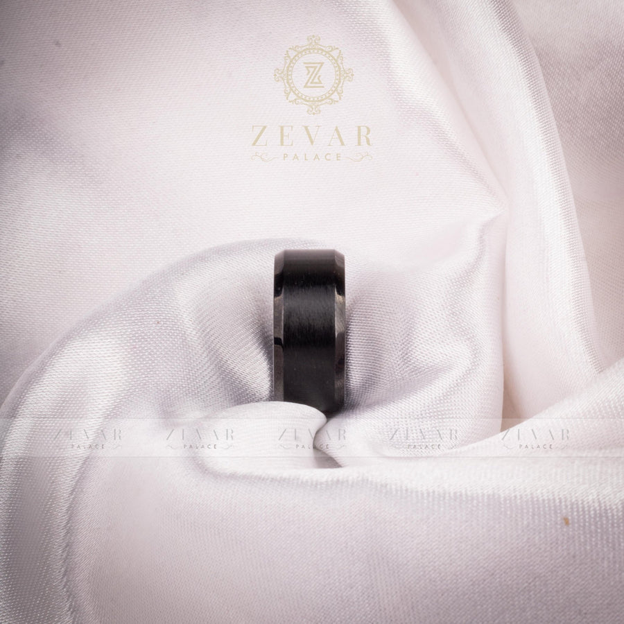 Black brushed titanium ring with polished beveled edges resting on white satin fabric with Zevar Palace logo