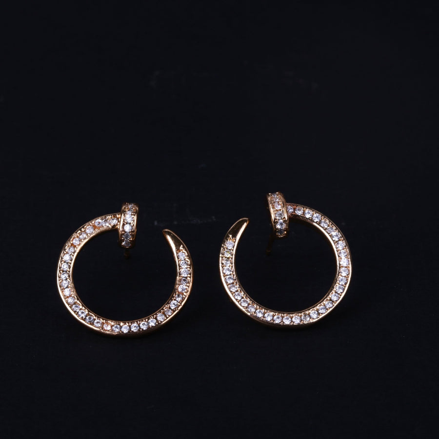 Pair of gold-tone sparkling rhinestone circle hoop earrings shown on black background