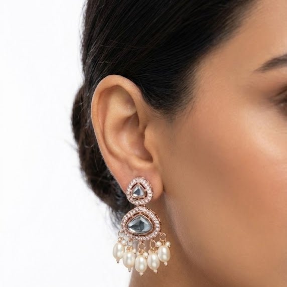 Woman wearing Noor Polki drop earrings displaying their elegant length and delicate pearl drops against her skin
