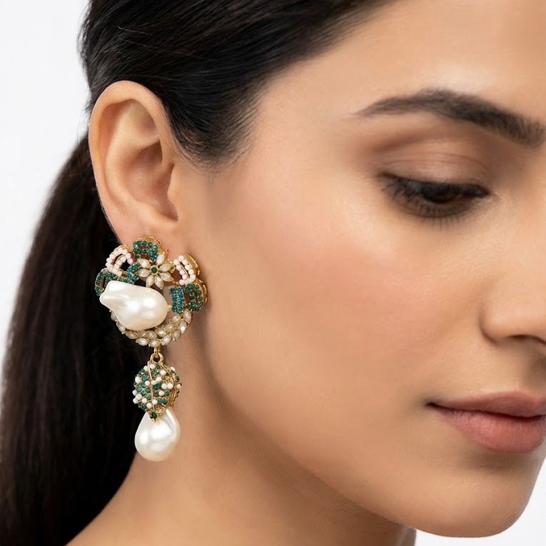 Model wearing green accented pearl drop earrings with floral design