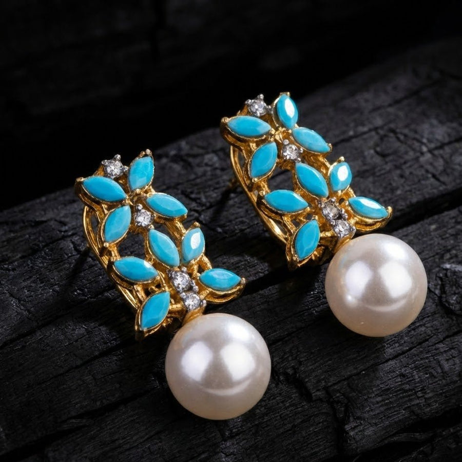Close-up image showing lustrous large white pearl drop under multicolor marquise-cut stone earrings