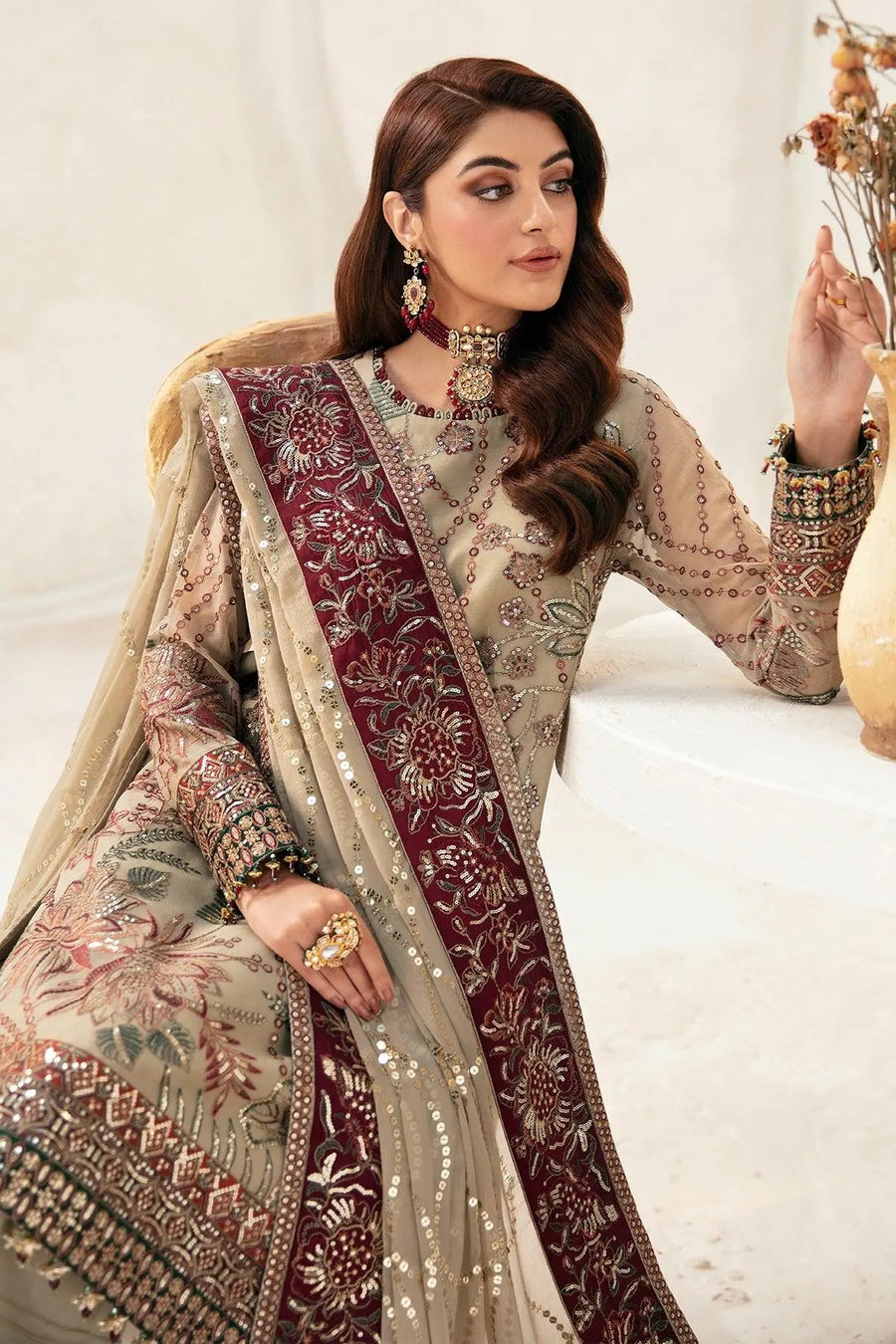 Close-up of neckline and cuff embroidery on beige chiffon shirt with maroon dupatta