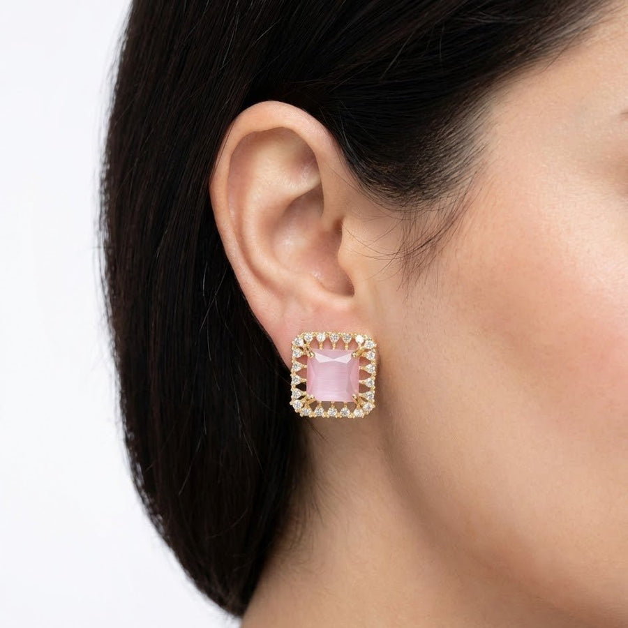 Female model wearing pink square halo stud earrings showing elegant and modest style