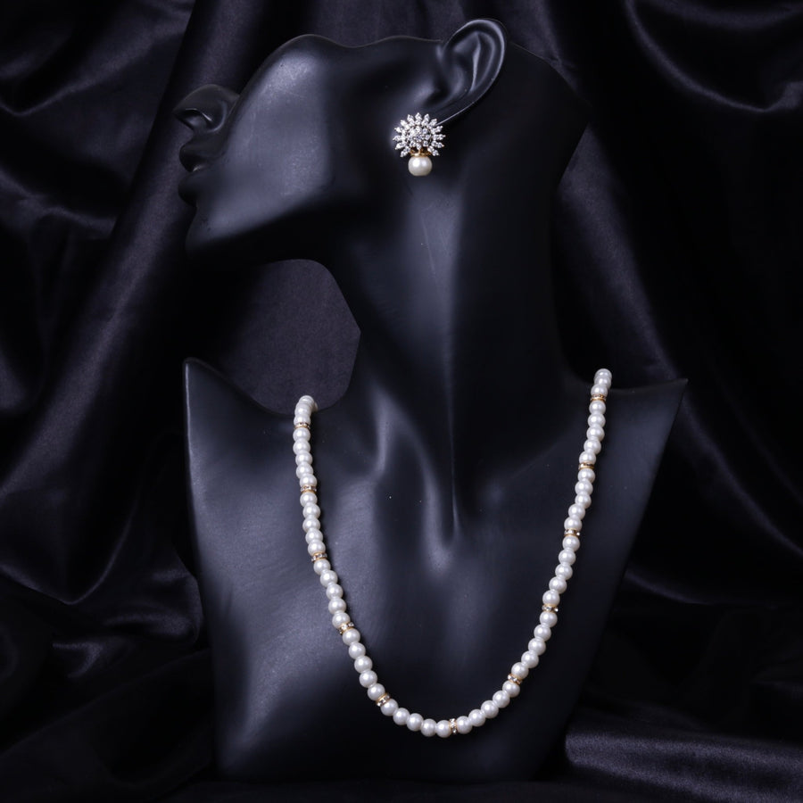 Front view of black mannequin displaying pearl necklace paired with crystal floral pearl earrings