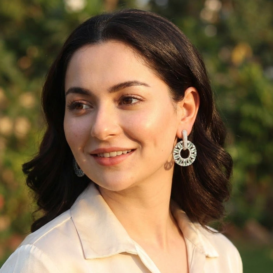Elegant silver plated clear stone circle drop earrings with baguette and round cuts on white background