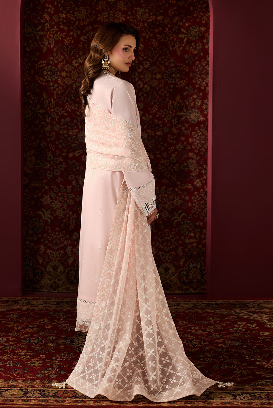 Back side view highlighting delicate embroidery on sleeves and dupatta draped over shoulder