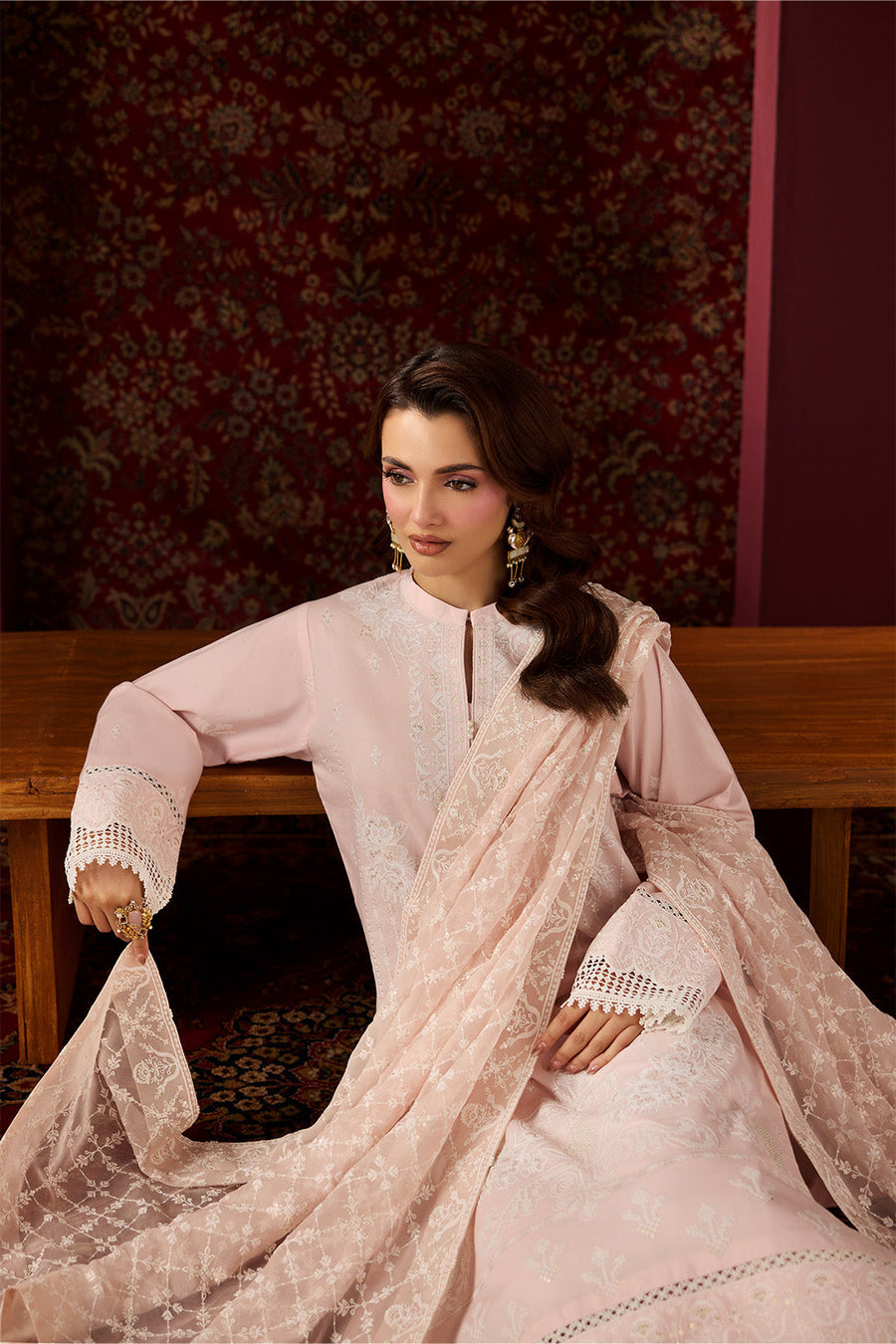 Close-up of detailed sleeve embroidery and lace scalloped edges