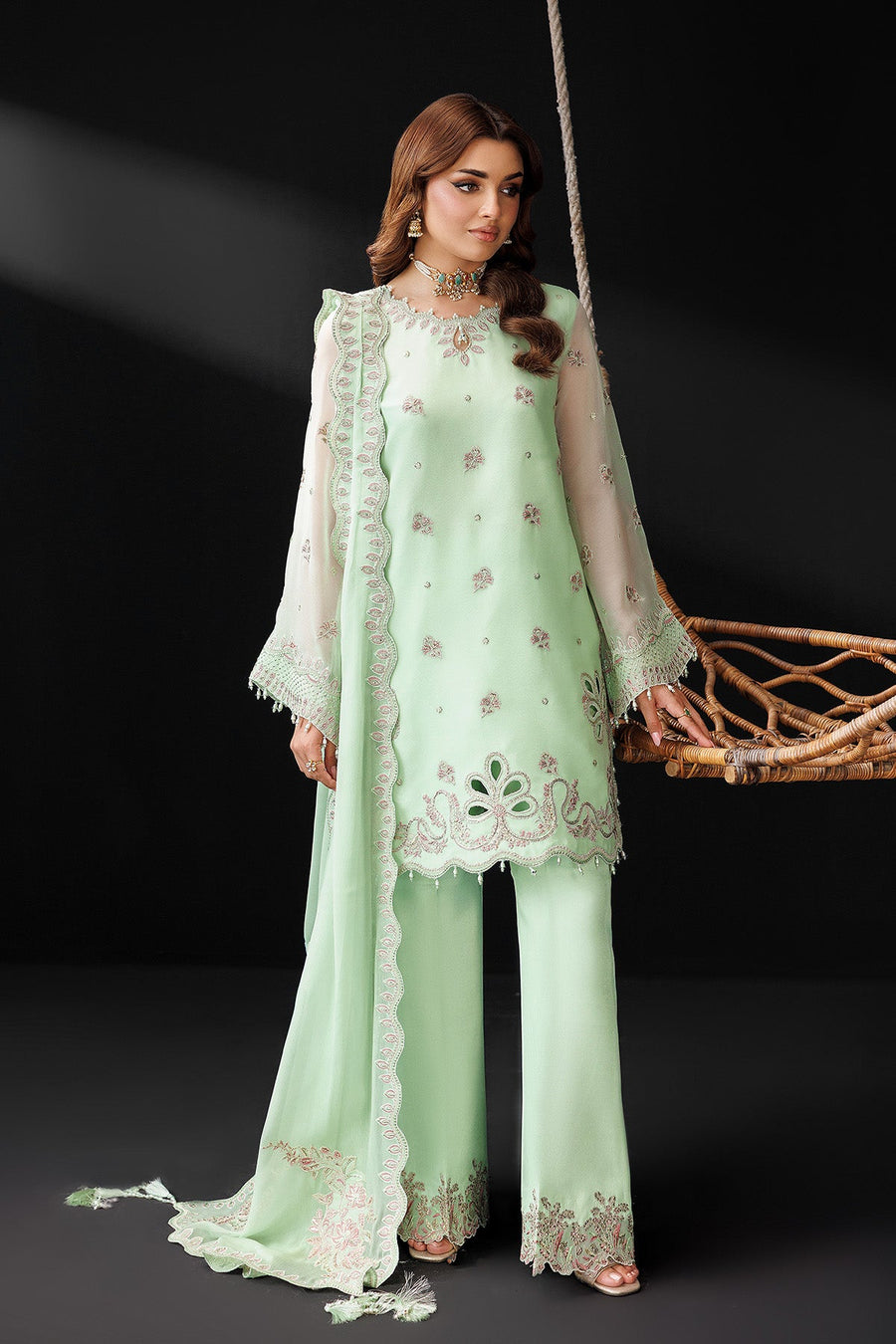 Full front pose showcasing the three-piece pastel green suit with embroidery and beaded details