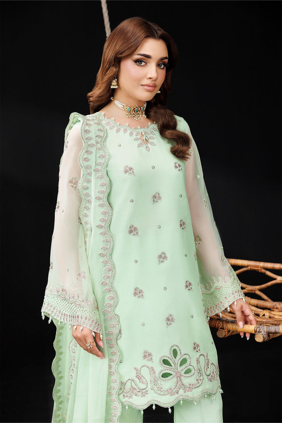 Portrait close-up showing delicate embroidery on the kurta front and matching jewelry