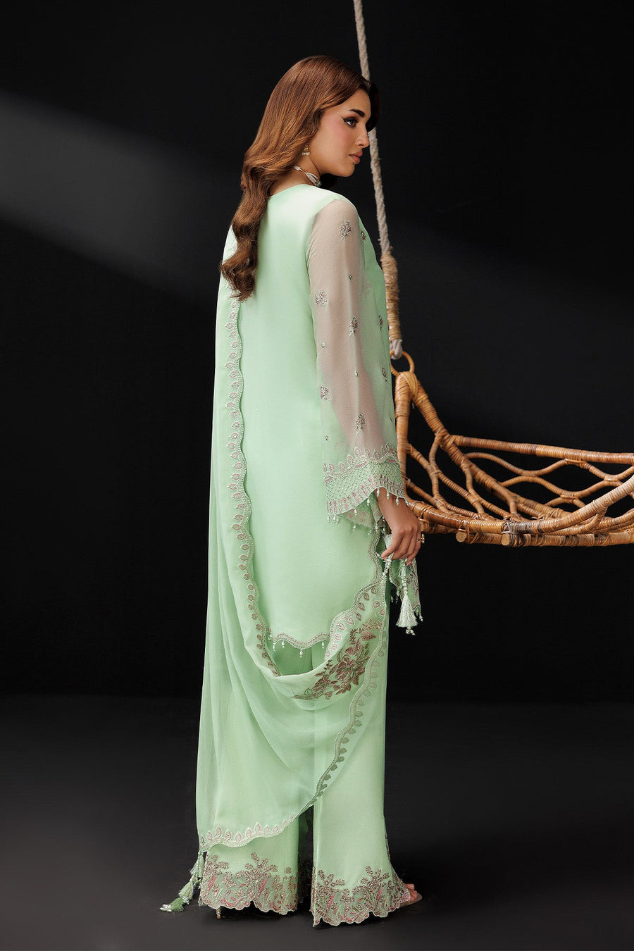 Side view showing embroidered detailing on chiffon sleeves and scalloped edges on kurta and dupatta