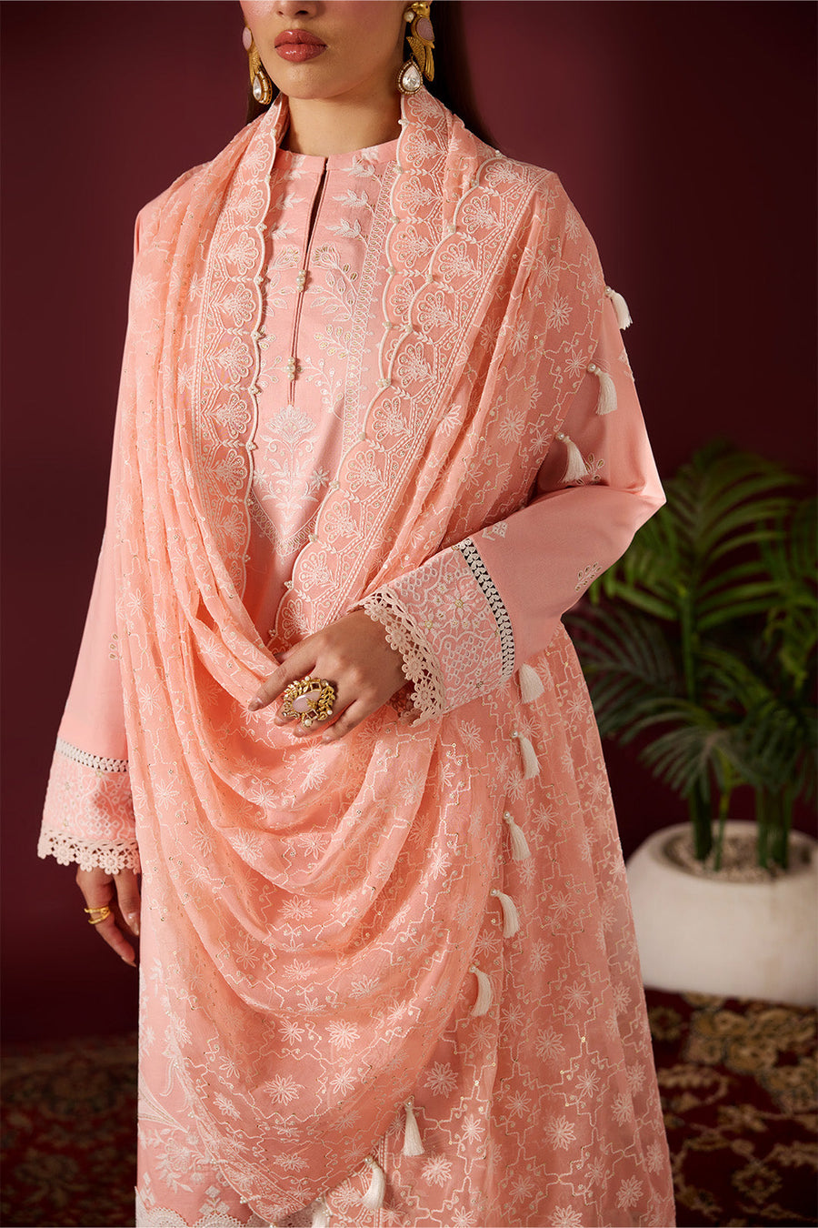 Close-up showing delicate embroidery on peach lawn dupatta and shirt sleeves