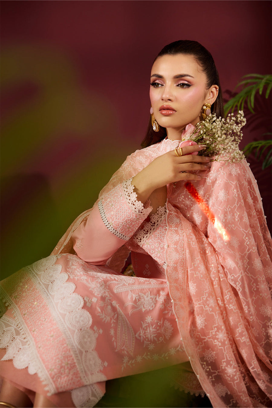 Detailed view of embroidered lace borders on trousers and shirt with dupatta