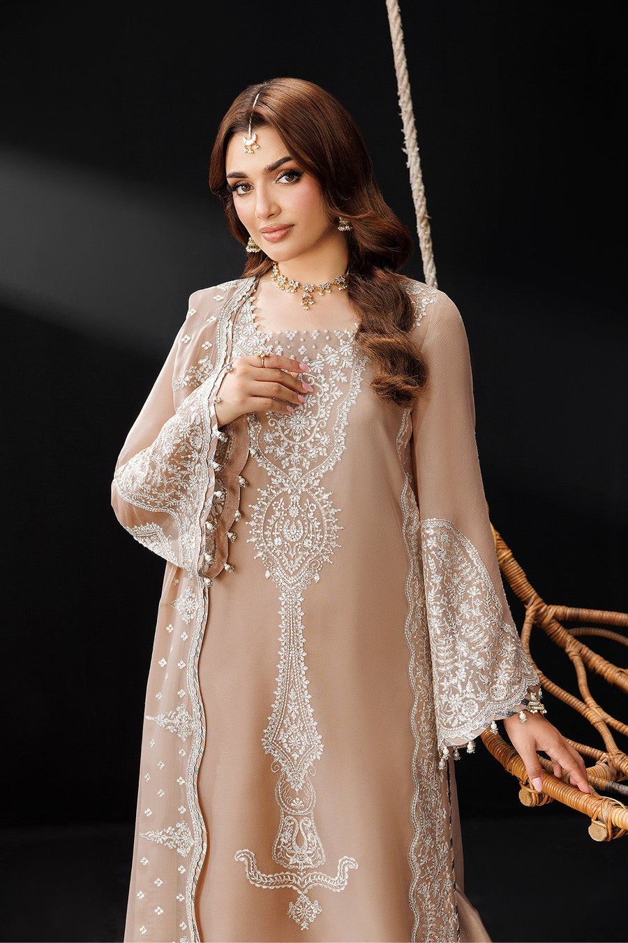 Side-angle showing embroidered sleeve details and elegant flowing dupatta