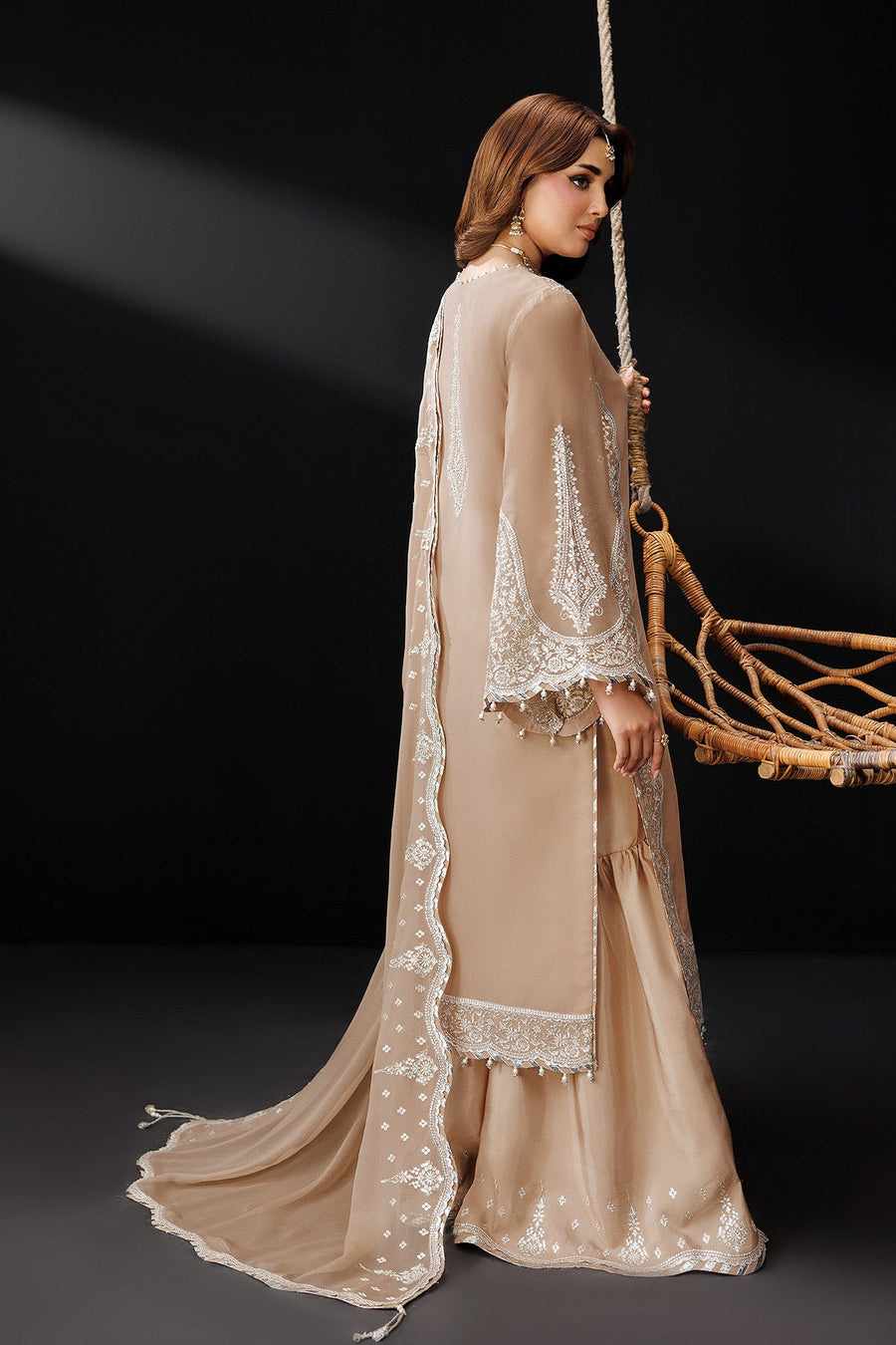 Side and back view showing embroidered details on sleeves and hem with flowing chiffon dupatta
