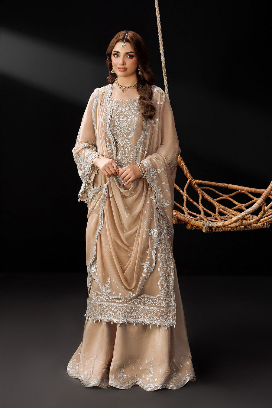 Full view of elegant traditional outfit with embroidered motifs and flowing chiffon dupatta