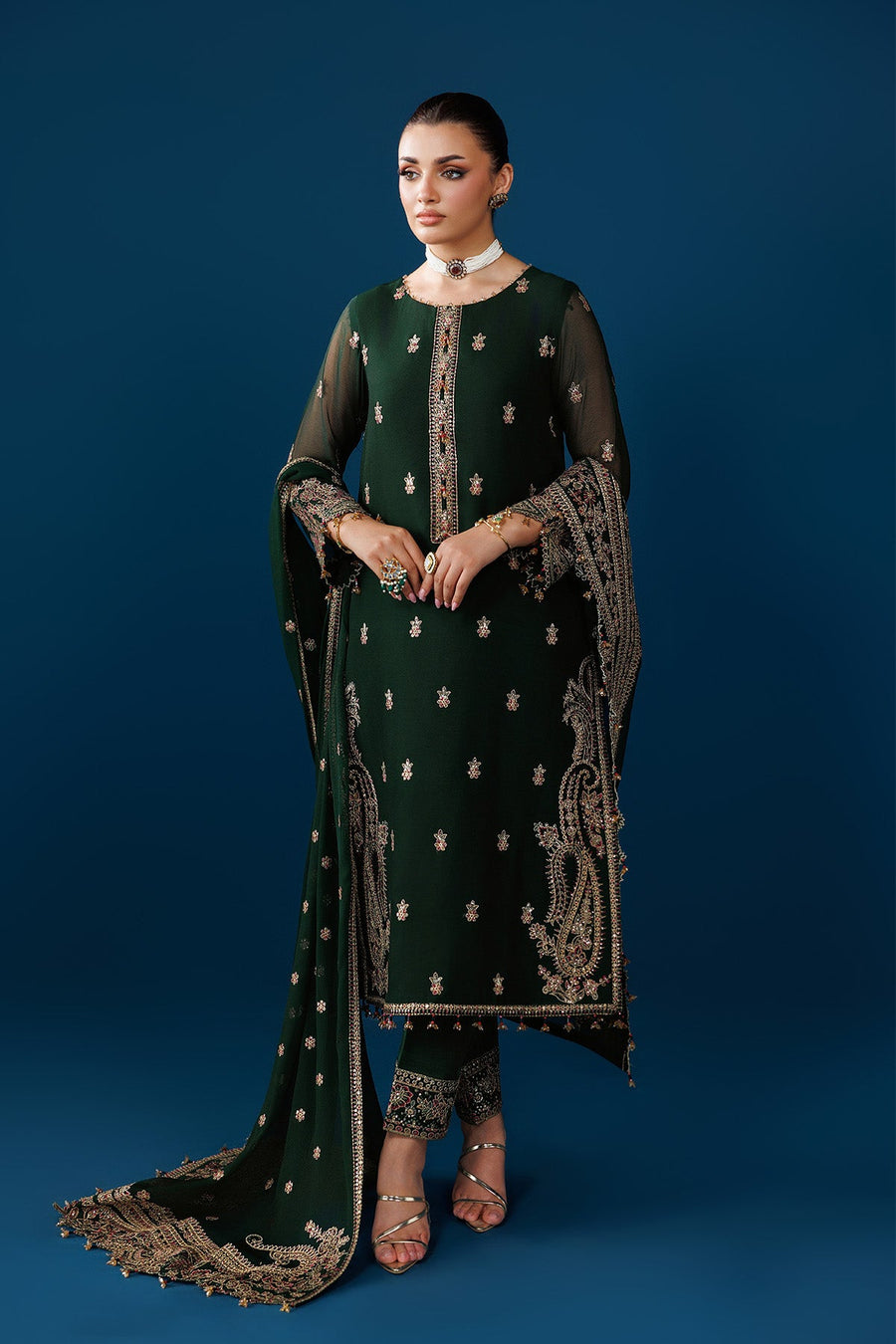 Model posing with embroidered emerald chiffon dupatta draped over shoulder