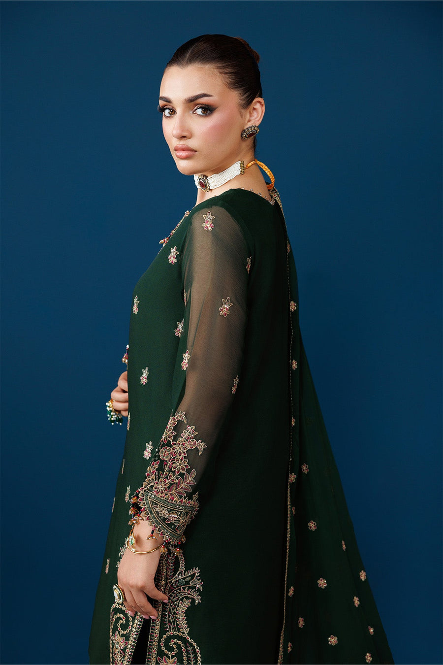 Detailed close-up of sleeve embroidery and fine fabric texture